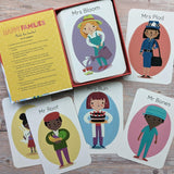 Card game with illustrated characters and instructions on a wooden surface